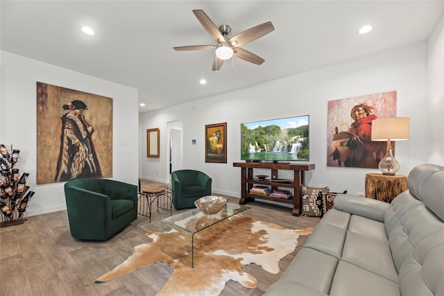 living room featuring a ceiling fan, recessed lighting, and wood finished floors