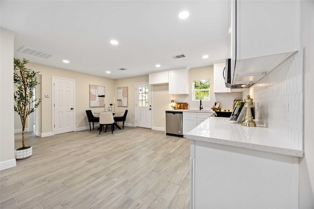 kitchen featuring dishwasher, white cabinets, visible vents, and light wood finished floors