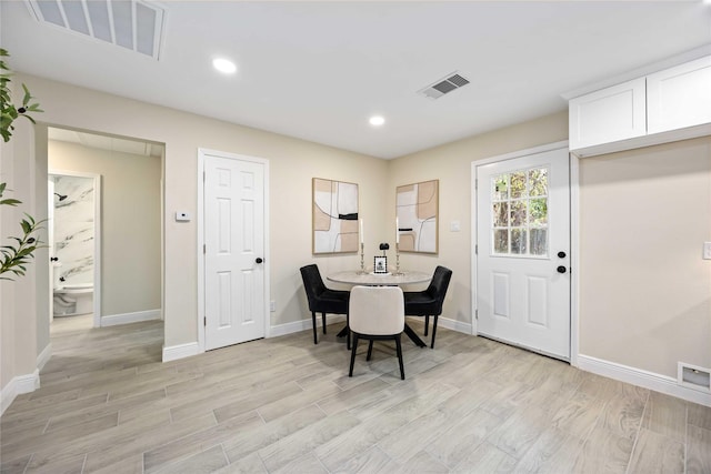 dining area with visible vents and light wood finished floors