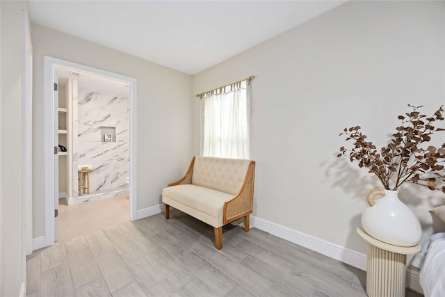 living area with wood finish floors and baseboards