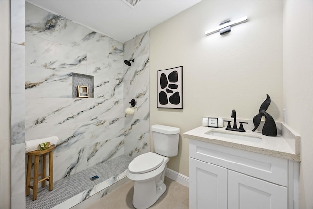 full bath featuring vanity, a shower stall, toilet, and baseboards