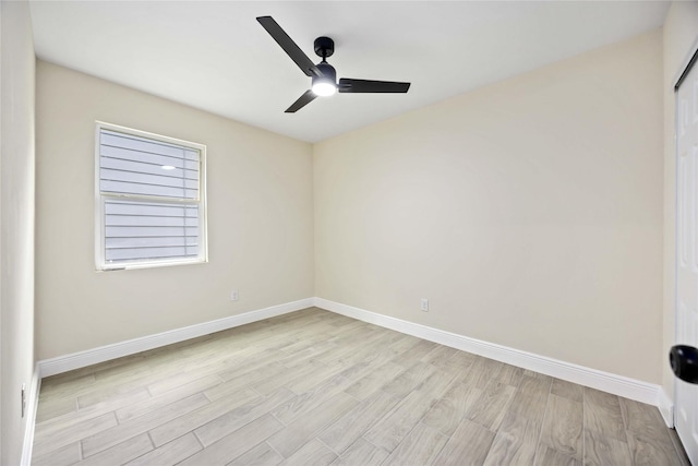 unfurnished room with baseboards, a ceiling fan, and light wood-style floors