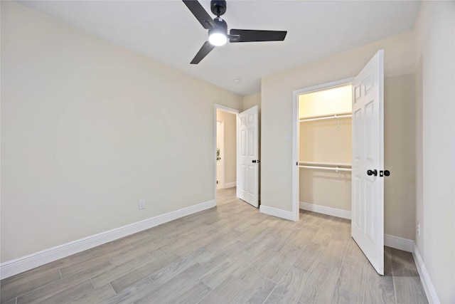 unfurnished bedroom with light wood-style flooring, baseboards, a closet, and ceiling fan