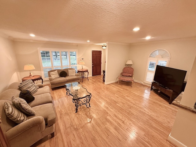 living room featuring light wood finished floors, crown molding, baseboards, recessed lighting, and a textured ceiling