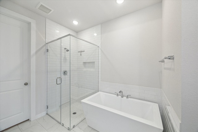 full bath with visible vents, a freestanding bath, marble finish floor, and a shower stall