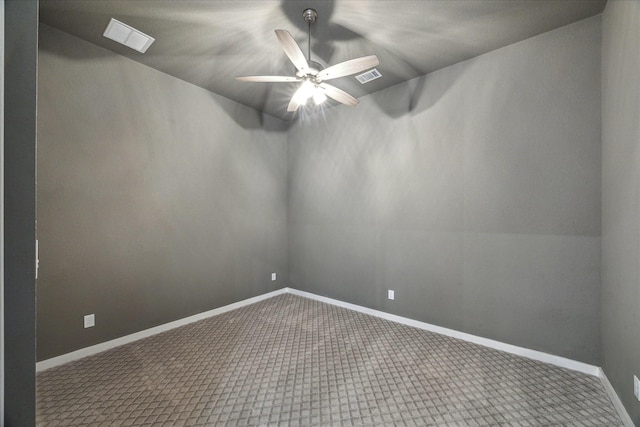 unfurnished room with baseboards, visible vents, and ceiling fan