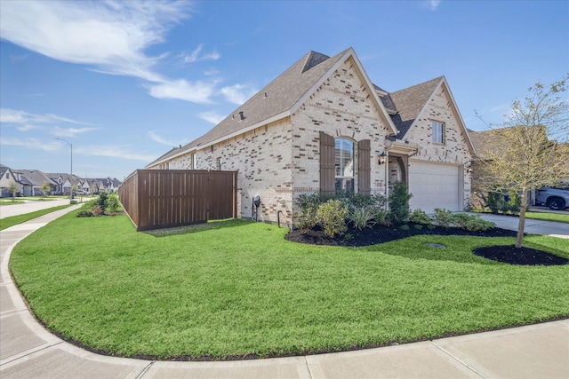 view of side of property with concrete driveway, a garage, brick siding, and a yard