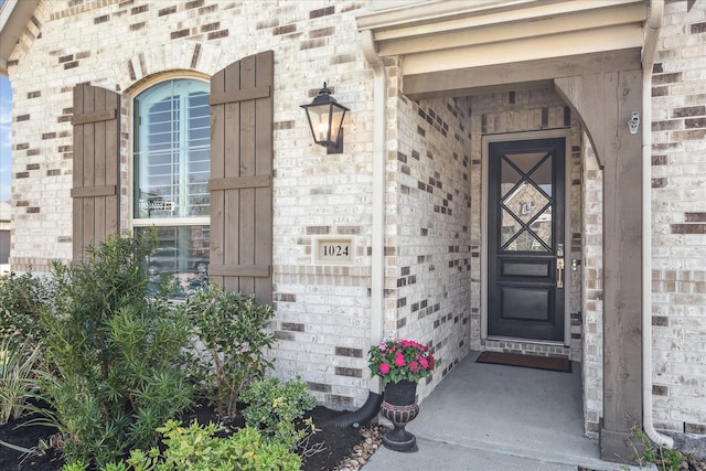 property entrance featuring brick siding