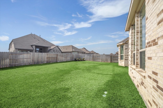 view of yard with a fenced backyard