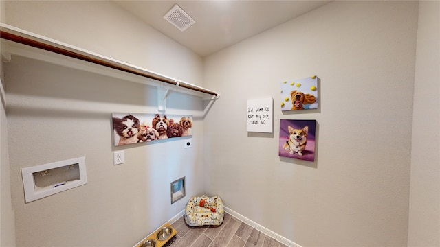 laundry room with hookup for a washing machine, wood finished floors, visible vents, hookup for an electric dryer, and laundry area