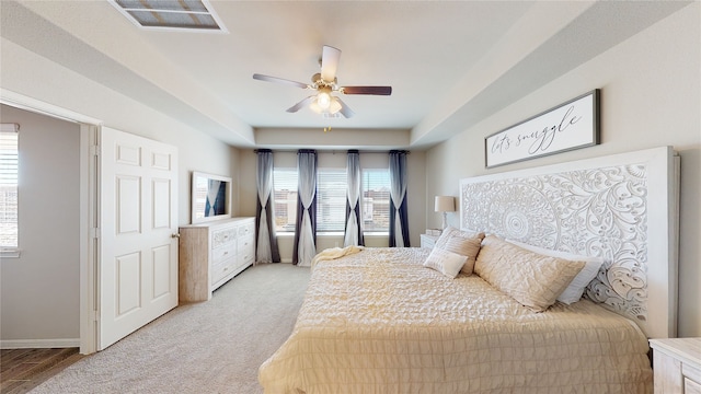 bedroom featuring visible vents, light carpet, baseboards, and ceiling fan