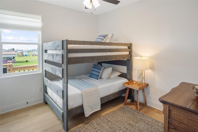 bedroom with wood finished floors, baseboards, and ceiling fan