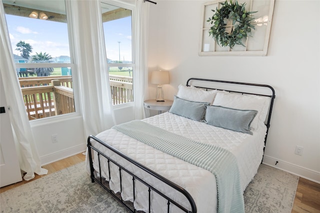 bedroom featuring baseboards and wood finished floors