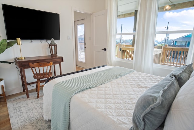 bedroom with baseboards and wood finished floors