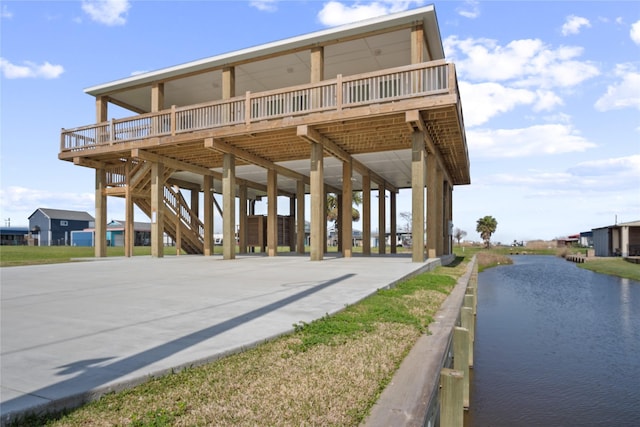 view of home's community featuring stairway and a water view