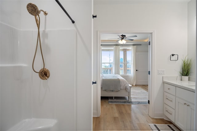 full bathroom featuring connected bathroom, a ceiling fan, walk in shower, and wood finished floors