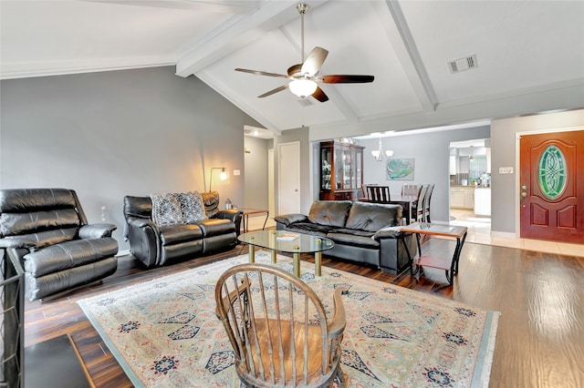 living room featuring wood finished floors, lofted ceiling with beams, a ceiling fan, and visible vents