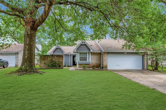 ranch-style home with brick siding, an attached garage, concrete driveway, and a front yard