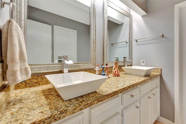 full bathroom featuring double vanity and a sink