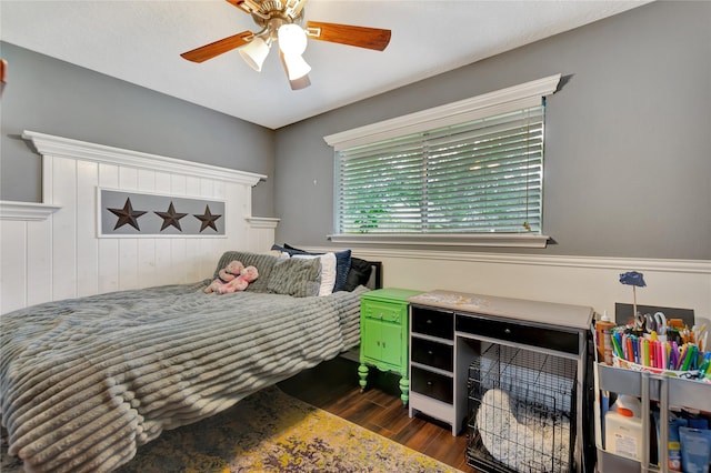 bedroom with a ceiling fan and dark wood-style flooring