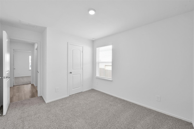 unfurnished bedroom featuring baseboards and carpet flooring