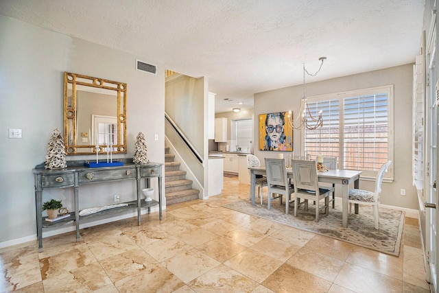 dining space with visible vents, baseboards, stairs, an inviting chandelier, and a textured ceiling