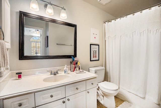 bathroom featuring toilet, vanity, and a ceiling fan