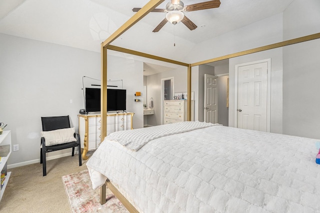 bedroom featuring a ceiling fan, vaulted ceiling, light colored carpet, and baseboards