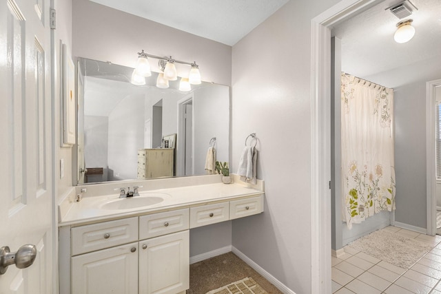 bathroom featuring vanity, baseboards, visible vents, curtained shower, and tile patterned floors