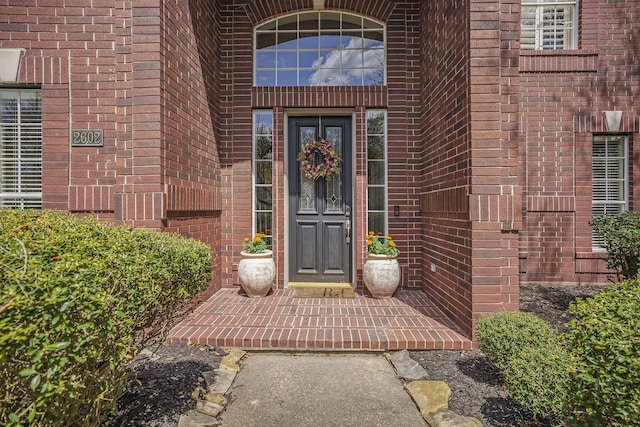 property entrance with brick siding