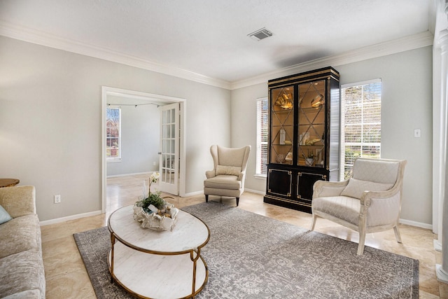 living room featuring visible vents, baseboards, and ornamental molding