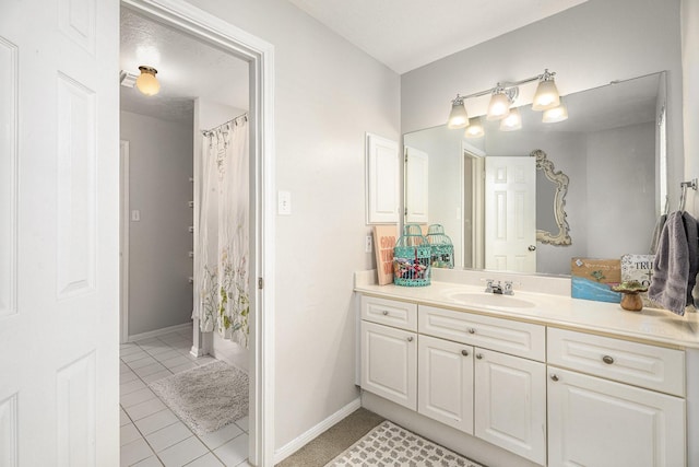 full bathroom featuring tile patterned floors, vanity, and baseboards