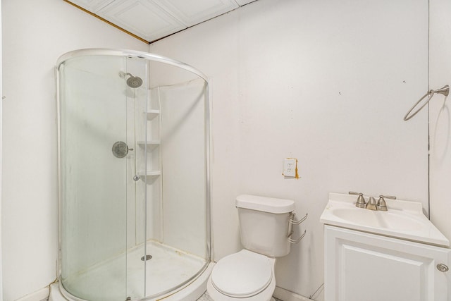 bathroom featuring vanity, a shower stall, and toilet