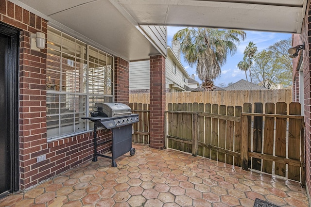 view of patio / terrace featuring grilling area and fence