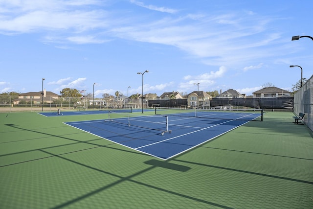 view of sport court featuring fence