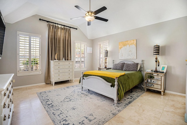 bedroom featuring lofted ceiling, multiple windows, and baseboards