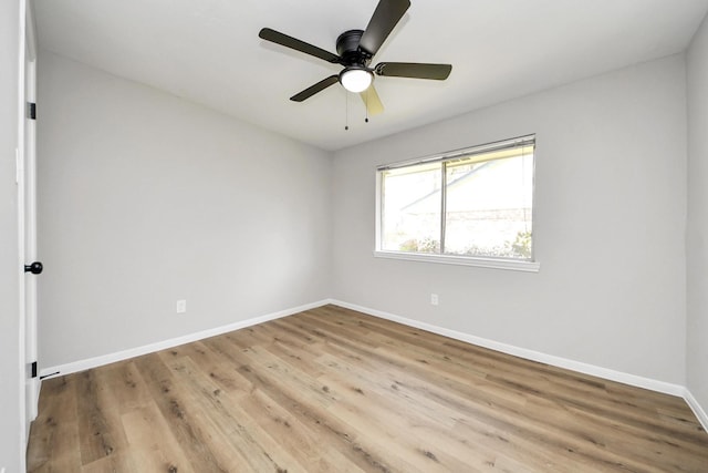 unfurnished room featuring a ceiling fan, wood finished floors, and baseboards