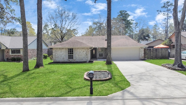 ranch-style home with a front lawn, fence, concrete driveway, a garage, and brick siding