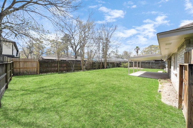 view of yard featuring a patio area and a fenced backyard