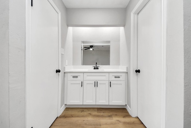 bathroom featuring vanity, a ceiling fan, and wood finished floors