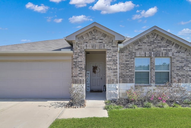 view of front facade featuring concrete driveway, an attached garage, brick siding, and stone siding