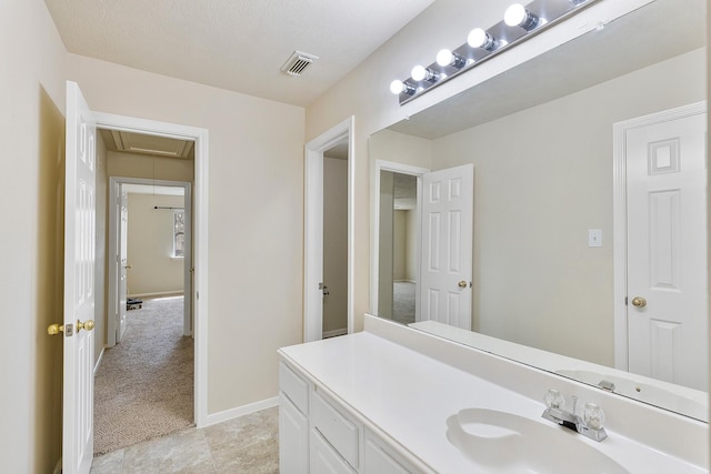 bathroom featuring visible vents, baseboards, and vanity