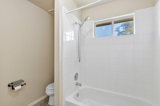 bathroom featuring baseboards, toilet, and  shower combination