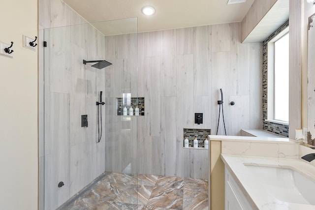 full bath featuring plenty of natural light, a walk in shower, and vanity