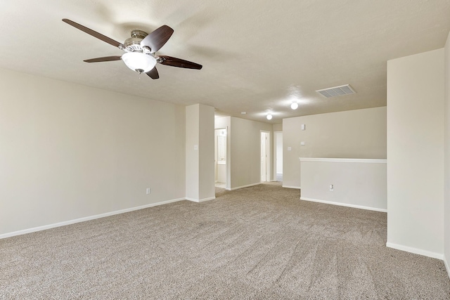 spare room featuring visible vents, baseboards, carpet flooring, and a ceiling fan