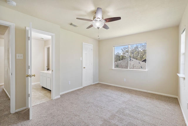 unfurnished bedroom with baseboards, visible vents, and light carpet