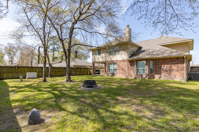 view of yard with a fenced backyard and an outdoor fire pit