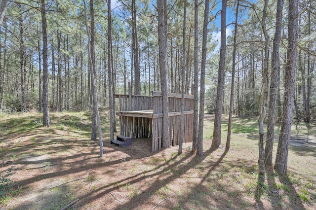 view of yard featuring a wooded view