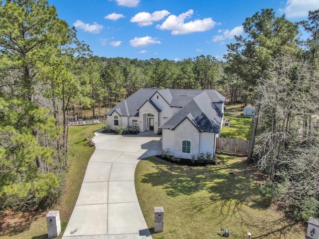 birds eye view of property with a view of trees