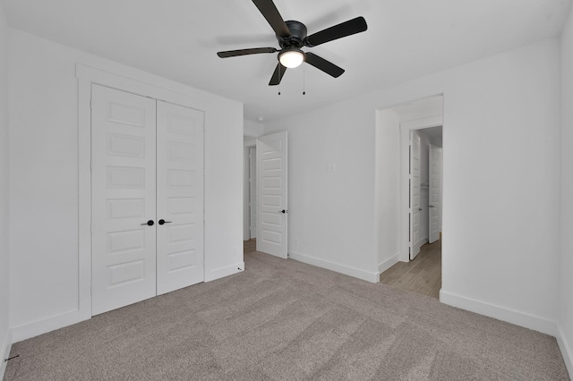 unfurnished bedroom featuring a closet, baseboards, carpet, and ceiling fan